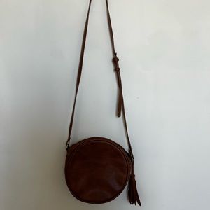 Circular leather cross-body purse